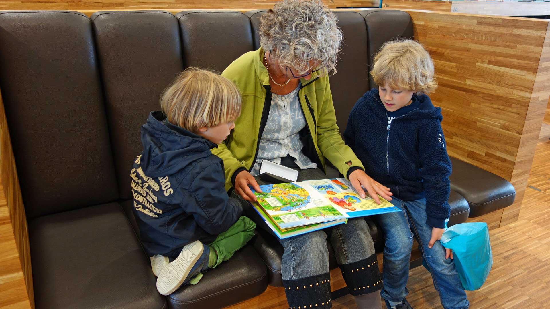 A grandparent reading with grandchildren.
